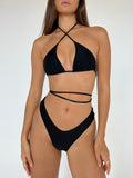 A black swimsuit with a strappy top and high-cut thong bottoms.
