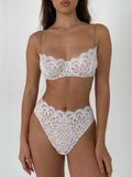 A lingerie set with high thongs, featuring a floral lace pattern in a light milk shade color.