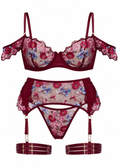 Floral lingerie set with bra, panties, and garter belt on a white background
